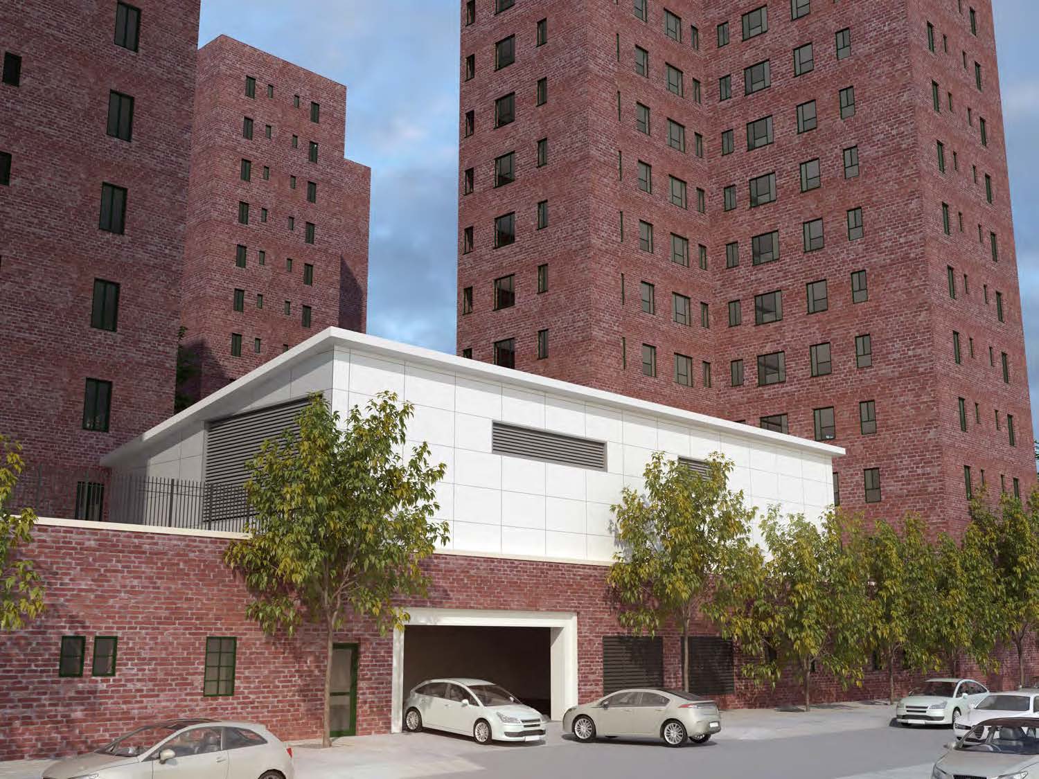 Street-level view along Avenue C with the white metal-clad energy building and its horizontal louvers set into a base of existing red-brick walls beneath tall residential towers.