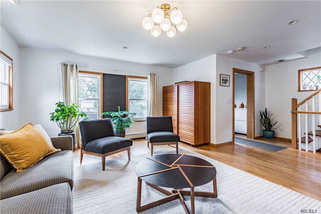 Main living space at Walnut House with seating grouped around a circular coffee table, looking towards the front.
