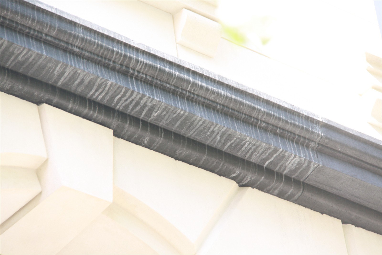 Stainless steel gutter and fascia at the edge of the terrace over the garage